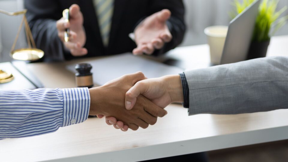 This image captures a moment of agreement or conclusion in a professional, likely legal or business, setting.